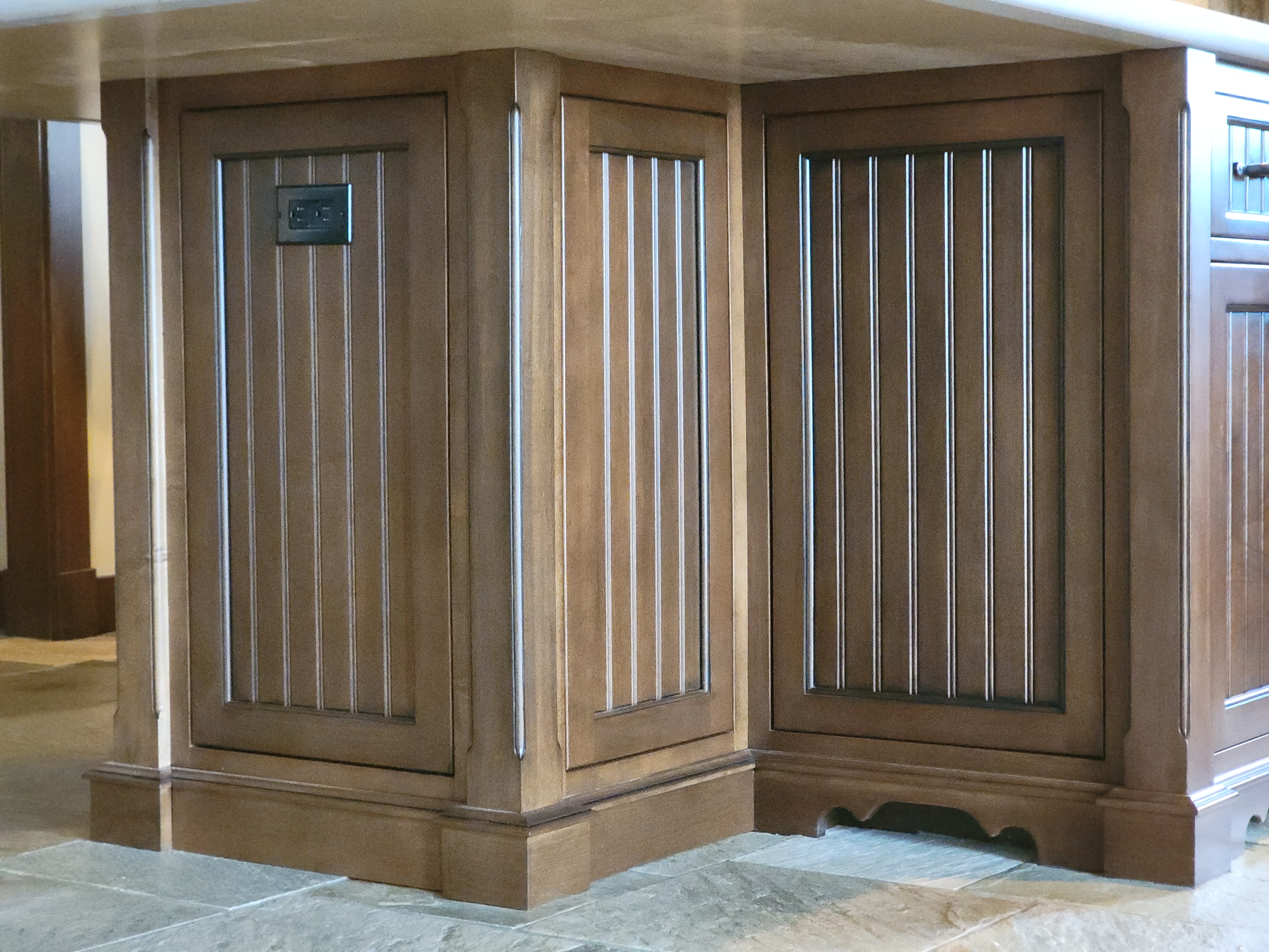 Furniture-style island rebuild with grooved shaker maple cabinetry and custom detailing.